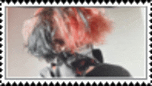 a close up of a person 's face with red hair and a black shirt .
