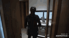 a woman standing in a room with the words made in animatica on the bottom right