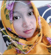 a woman wearing a yellow scarf with purple flowers