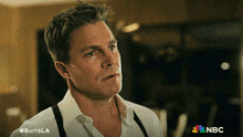 a man wearing a white shirt and suspenders is featured on a nbc ad