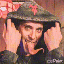 a man with his tongue out wearing a hoodie
