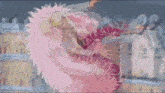 a man in a pink feathered costume is flying through the air