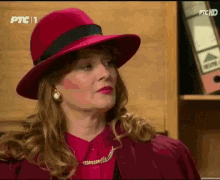 a woman wearing a red hat and a red jacket is on ptc