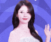 a woman in a white dress waves her hand