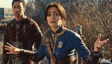 a man and a woman standing next to each other with the word fallout on the bottom right