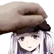 a hand is putting a hat on the head of a girl .
