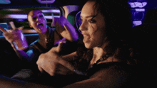 two women are sitting in a car and one of them is pointing