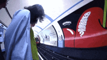 a person standing next to a train with a sign that says ' northern ' on it