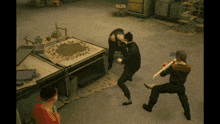 a video game scene with a man holding a stick and another man holding a gun