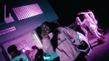 a man in a balenciaga jacket is dancing in front of a group of people