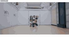 a group of women are posing for a picture in a dance studio with the word wine on the wall