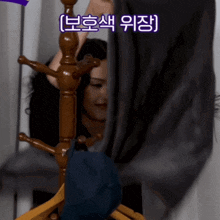 a woman is standing behind a clothes rack with chinese writing on the bottom