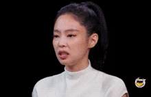a woman with a ponytail is laughing with her eyes closed and her mouth open .