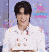 a man is holding a birthday cake with a candle and the words happy birthday written above him