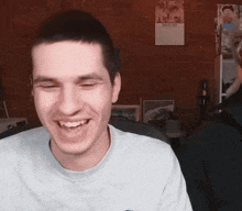 a man is laughing in front of a wall with a calendar on it that says march 2020