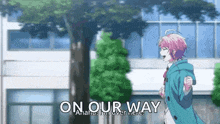 a girl with pink hair is running in front of a building with the words `` on our way '' written on it .