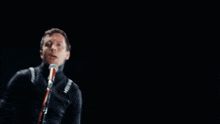 a blurry picture of a man singing into a microphone with the word mozart in the background