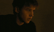 a close up of a man 's face in the dark