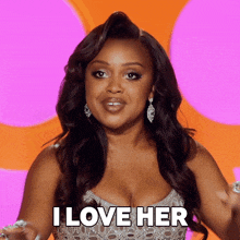 a woman says " i love her " while wearing a silver dress