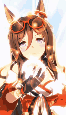 a girl with glasses and gloves is holding a ball in her hands