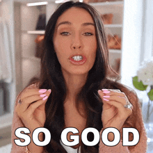 a woman with pink nails says so good in front of her