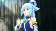 a girl with blue hair is standing in front of a tree .