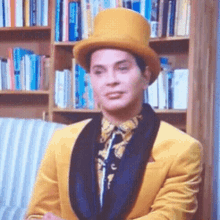 a man wearing a yellow top hat and a yellow suit