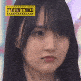 a close up of a woman 's face with a yellow sign that says under construction .