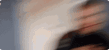 a blurry picture of a person 's face with a white background