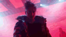 a man in a fur coat stands in front of a red light