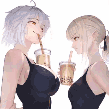 a girl with a straw in her mouth drinks from a cup next to another girl