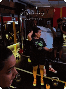 a woman wearing a black nike shirt is standing in front of a mirror
