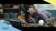 a man and a woman are looking at a laptop with the words freelancers anonymous behind them