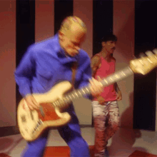Jumping While Playing The Guitar Flea GIF - Jumping While Playing The Guitar Flea Red Hot Chili Peppers GIFs