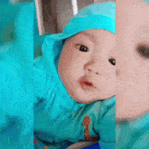 a baby is wearing a blue outfit with a giraffe on the front
