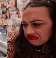 a woman with red lipstick on her lips is making a face .