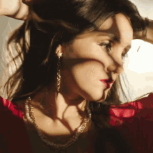 a close up of a woman 's face with the sun shining on her face