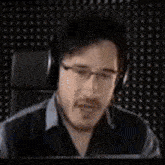 a man is screaming in a dark room with his mouth open .