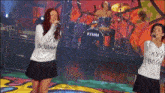 a woman singing in front of a drum set that says tama