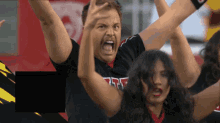 a group of cheerleaders are cheering with a man wearing a shirt that says ff on it