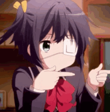 a girl with a bandage on her eye is pointing her finger .