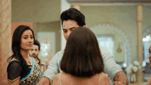 a man and a woman are dancing in a room