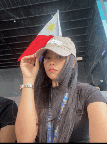 a woman wearing a hat that says carlsberg