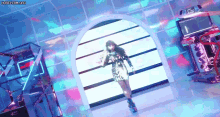 a woman in a dress is dancing in a room with a lot of lights on it .