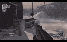a person is playing a video game in the snow with a gun .