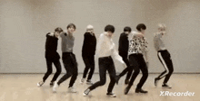 a group of young men are dancing together in a studio .