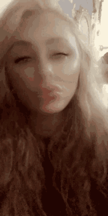 a close up of a woman 's face with closed eyes