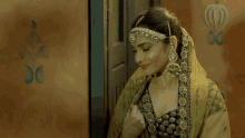 a woman in a yellow and black dress with a headpiece