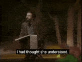 a man with a beard stands at a podium with the words they have never understood and no reason that they should