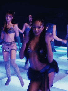 a woman in a bikini is dancing in a club